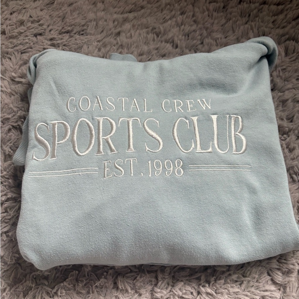 Cozy Blue Crewneck Sweater with Crystal Cove Sports Club Design